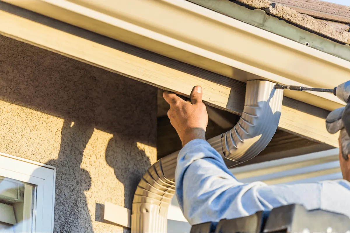 Professional gutter replacement process showing fascia repair